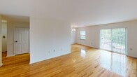 Located at 1825 Center St in Bethlehem, PA, this single-floor home offers a clean, well-maintained layout designed for comfortable living. Polished hardwood floors flow consistently throughout the main living areas and bedrooms, lending warmth and continuity to the interior.

The open living and dining area is bright and spacious, illuminated by natural light streaming through large windows and a sliding glass door that provides direct outdoor access. An elegant chandelier adds a refined touch to the dining space.

The kitchen is efficiently laid out with dark cabinetry, white countertops, light tile flooring, and a full suite of stainless steel appliances including a gas range, microwave, and refrigerator. A passthrough connects the kitchen seamlessly to the rest of the home.

The bedrooms are generously sized, each featuring gleaming hardwood floors, natural light from multiple windows, and dedicated closet space. One bedroom includes a walk-in closet, offering ample storage. Baseboard heating is present in several rooms.

The bathroom is finished in crisp white tile, featuring a full tub-shower combination, a vanity with a lighted mirror cabinet, and clean, classic fixtures throughout. The overall aesthetic of the home is bright and neutral, providing a versatile canvas for personalization.
