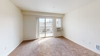 This well-designed 920 square foot apartment offers a comfortable living space with three bedrooms and two bathrooms. The open-concept layout seamlessly integrates the kitchen and living area, creating an inviting atmosphere for both relaxation and entertainment.

The kitchen is equipped with modern appliances, including a black refrigerator and stove. Wooden cabinets provide ample storage, while the countertops offer generous workspace. A kitchen island doubles as a breakfast bar, perfect for casual dining or food preparation.

The bedrooms feature plush carpeting, creating a cozy retreat. Large windows in the bedrooms allow natural light to flood the spaces, brightening the rooms and providing pleasant views. The primary bedroom, measuring 130 square feet, offers a spacious sanctuary for rest and relaxation.

Both bathrooms are well-appointed with wooden vanities, large mirrors, and ample lighting. One bathroom showcases a combination bathtub and shower, while hardwood flooring adds a touch of elegance to the space.

A standout feature is the balcony, accessible through sliding glass doors, which offers panoramic views of the surrounding cityscape. This outdoor space is ideal for enjoying morning coffee or evening relaxation.

Throughout the apartment, neutral-toned walls create a blank canvas for personalization, while the mix of carpet and hardwood flooring adds texture and warmth to the overall design. The apartment's layout maximizes the use of space, ensuring a comfortable and functional living environment.