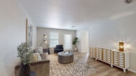 Located at 2550 W Ironwood Hill Dr in Tucson, Arizona, this single-floor residence offers a well-designed layout with a clean, contemporary aesthetic throughout. The living room is an inviting, open space featuring light wood-style flooring, neutral-toned walls, and multiple windows dressed with blinds that allow for ample natural light. The room comfortably accommodates a tufted sofa, accent chair, and a round stone coffee table, all anchored by a geometric-patterned area rug. A decorative honeycomb-panel console adds a stylish touch. The kitchen is efficiently laid out with white cabinetry, light quartz countertops, and a full suite of stainless steel appliances including a refrigerator, over-the-range microwave, and electric range. A undermount single-basin sink is positioned on the peninsula, offering additional prep space. The bedroom provides a calm retreat, complete with light wood-style flooring, a ceiling fan with integrated lighting, a window for natural light, and neutral walls that lend a serene atmosphere. The bathroom features a generous dual-sink vanity with white cabinetry and quartz countertops, a large mirror, and a shower-tub combination. Light wood-style flooring continues seamlessly throughout the space, unifying the overall design.