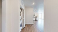 Located at 2375 E 104th Ave in Thornton, Colorado, this single-floor, 2-bedroom, 2-bathroom home offers a clean, modern aesthetic throughout. The open-concept living and kitchen area is anchored by durable wood-look flooring and recessed lighting, creating a bright and welcoming atmosphere. The well-appointed kitchen features white shaker cabinetry, granite countertops, and a full suite of stainless steel appliances including a refrigerator, range, microwave, and dishwasher. A convenient in-unit stacked washer and dryer is tucked neatly into a dedicated laundry closet just off the main living area. Both bedrooms are carpeted for comfort — the spacious primary bedroom includes a walk-in closet with wire shelving — while a second bedroom offers wood-look flooring and a bright window with neighborhood views. The bathrooms are finished with granite vanity countertops, white cabinetry, wood-look flooring, and a tiled tub-shower surround. Three closets in total provide ample storage throughout. Neutral tones and clean white walls give the entire home a fresh, move-in-ready feel, well-suited for comfortable everyday living.