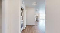 Located at 2375 E 104th Ave in Thornton, Colorado, this single-floor, 2-bedroom, 2-bathroom home offers a clean, modern aesthetic throughout. The open-concept living and kitchen area is anchored by durable wood-look flooring and recessed lighting, creating a bright and welcoming atmosphere. The well-appointed kitchen features white shaker cabinetry, granite countertops, and a full suite of stainless steel appliances including a refrigerator, range, microwave, and dishwasher. A convenient in-unit stacked washer and dryer is tucked neatly into a dedicated laundry closet just off the main living area. Both bedrooms are carpeted for comfort — the spacious primary bedroom includes a walk-in closet with wire shelving — while a second bedroom offers wood-look flooring and a bright window with neighborhood views. The bathrooms are finished with granite vanity countertops, white cabinetry, wood-look flooring, and a tiled tub-shower surround. Three closets in total provide ample storage throughout. Neutral tones and clean white walls give the entire home a fresh, move-in-ready feel, well-suited for comfortable everyday living.