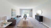 This single-floor residence at 8301 S Cork Ave in Justice, IL, offers a well-organized layout designed for comfortable everyday living. The spacious living room serves as the central gathering area, featuring neutral carpet flooring, a wall-mounted air conditioning unit, and a large sliding glass door that opens to a private balcony with views of surrounding greenery, filling the room with natural light.

Adjacent to the living area, the dining space accommodates a round table and seating, with dark hardwood-style flooring that continues into the kitchen. The kitchen is efficiently designed with ample cabinetry in a neutral finish, a tile backsplash, gas range, full-size refrigerator, and a double sink — providing functional storage and prep space. A dedicated dining nook offers a defined area for meals.

The unit includes two carpeted bedrooms, both benefiting from natural light through sizable windows. The primary bedroom provides enough space for a full bedroom suite, while the secondary bedroom features baseboard heating and flexible furniture arrangements.

The bathroom is finished with clean white tile surrounding a full tub-shower combination, a vanity with storage cabinetry, and a mirrored medicine cabinet, maintaining a practical and tidy aesthetic throughout.
