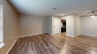 Located at 200 Old Boiling Springs Rd in Greer, SC, this single-story, 2-bedroom, 1-bathroom home offers a practical and comfortable layout. The living room serves as the heart of the space, featuring warm wood-look vinyl flooring, neutral-toned walls, a ceiling fan, and a window fitted with blinds that allows natural light to filter in. The open sightline to the kitchen creates a connected feel throughout the common areas. The kitchen is equipped with dark cabinetry, granite-style countertops, a black electric range with an over-the-range microwave, and a sink — providing all the essentials in a compact, efficient footprint. Both bedrooms are carpeted in a neutral tone and offer a calm, restful atmosphere. The spacious primary bedroom includes a window with outdoor views and access to a dedicated closet. The second bedroom is similarly designed with carpet flooring and ample wall space. The bathroom features a full tub and shower combination with chrome fixtures. Throughout the home, textured ceilings, clean white trim, and consistent neutral color palettes contribute to a cohesive, move-in-ready aesthetic. Three closets provide generous storage across the floor plan.
