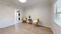 Located at 3215 W Swann Ave in Tampa, FL, this well-appointed one-bedroom, one-bathroom unit offers a thoughtfully designed single-floor layout. The living and dining areas flow seamlessly together, featuring light wood-look flooring, crisp white walls, and elegant crown molding throughout that lend a clean, polished aesthetic. Natural light filters in through windows, enhancing the bright and airy feel of the space.

The kitchen is a standout feature, showcasing white shaker-style cabinetry, granite countertops, a classic white subway tile backsplash, and a full suite of stainless steel appliances including a refrigerator, range, and microwave. Light tile flooring completes the kitchen's clean look.

The bedroom is a comfortable retreat with wood-look flooring, crown molding, a ceiling fan, a window with natural light, and access to multiple closets, including a louvered closet and a walk-in closet. The bathroom features tile flooring and a full tub/shower combination.

A dedicated laundry area with a stacked washer and dryer provides added everyday convenience. With three closets total, storage is plentiful throughout the unit. The consistent use of neutral tones and classic finishes creates a cohesive and welcoming living environment.