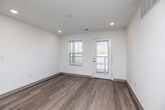 Located on Mission Circle in Waterloo, Iowa, this single-floor residence offers a clean, modern design across two bedrooms and two full bathrooms. Light hardwood-style flooring runs throughout the home, complementing the crisp white walls and recessed lighting that give every room a bright, airy feel. The open kitchen and living area forms the heart of the home, featuring white shaker cabinetry, light stone countertops, and a full suite of black appliances including a refrigerator, range, dishwasher, and over-the-range microwave. The primary bedroom is a comfortable, well-proportioned retreat with natural light from windows and convenient access to closet space. The second bedroom is equally bright, with a window overlooking the exterior. Both bathrooms are finished with gray vanity cabinetry, stone-look countertops, and light wood-style flooring; one includes a full soaking tub and shower combo. The residence also includes a dedicated laundry area and utility room, as well as five closets providing generous storage throughout. A private exterior door off the main living area offers added convenience. The overall aesthetic is modern, neutral, and move-in ready.
