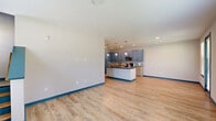 This well-appointed two-story townhome in Titusville, Florida offers 3 bedrooms and 4 bathrooms across two thoughtfully laid-out floors. A signature teal color accent runs throughout the home — from door frames and baseboards to cabinet hardware — lending a cohesive and modern aesthetic.

The main floor features an open-concept kitchen and living area with warm wood-look luxury vinyl plank flooring. The kitchen stands out with dual-tone cabinetry in teal and light wood, dark granite countertops, stainless steel appliances, a decorative tile backsplash, pendant lighting, and a central island. A glass door opens directly to the outdoors, and multiple windows flood the living area with natural light.

Upstairs, the primary bedroom is generously sized with plush carpet, a ceiling fan, and multiple windows. It is complemented by a well-designed en-suite bathroom featuring granite-topped vanity with undermount sink and a glass-enclosed walk-in shower with floor-to-ceiling tile surround. A spacious walk-in closet with wire shelving provides ample storage. Additional bedrooms are carpeted and bright, each with teal-trimmed doors. The attached garage includes an automatic opener and protective bollard. This townhome combines functional design with distinctive styling throughout.