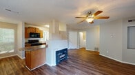 Located at 3904 Mill Tree Rd in Raleigh, NC, this single-floor home offers a well-designed layout with a seamless blend of comfort and functionality. The open-concept living and dining area is anchored by a classic fireplace set into a painted brick surround, complemented by rich hardwood-style flooring and a ceiling fan that enhances air circulation throughout the space. Large windows flood the area with natural light, and a glazed door provides direct access to an outdoor deck with views of the surrounding greenery.

The kitchen is efficiently laid out with warm-toned wood cabinetry, granite-look countertops, and a full suite of black appliances including a range, microwave, dishwasher, and refrigerator. A breakfast bar peninsula connects the kitchen to the living area, making it ideal for casual dining or entertaining.

The bedrooms feature plush carpeting and sliding glass doors that open to the deck, offering a seamless indoor-outdoor connection and ample natural light. The bathroom is finished with rich wood cabinetry, a granite-look vanity top, hardwood-style flooring, and a well-lit mirror arrangement. Additional utility space is visible within the floor plan, rounding out this thoughtfully designed single-level home.