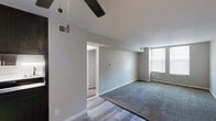 Located at Century City S in Reynoldsburg, Ohio, this one-bedroom, one-bathroom unit offers a thoughtfully organized single-floor layout. The combined kitchen and living area serves as the heart of the space, where the kitchen stands out with rich dark-espresso cabinetry, crisp white countertops, black gas appliances, a deep stainless steel sink with a matte black faucet, and light wood-look flooring that adds warmth and durability. The living area transitions seamlessly with plush carpeting underfoot, neutral gray walls, a ceiling fan overhead, and a window that draws in natural light, creating a comfortable and open atmosphere. A hallway connects the main living space to the private quarters. The bedroom is a well-sized retreat featuring soft carpeting, a large window with blinds for natural light and privacy, neutral gray walls, and a closet with sliding doors for convenient storage. The bathroom is clean and functional, complete with a full tub and shower combination, wood-look flooring, and white walls that keep the space feeling bright. Throughout the unit, consistent neutral tones, white trim, and updated finishes contribute to a cohesive, move-in-ready aesthetic.