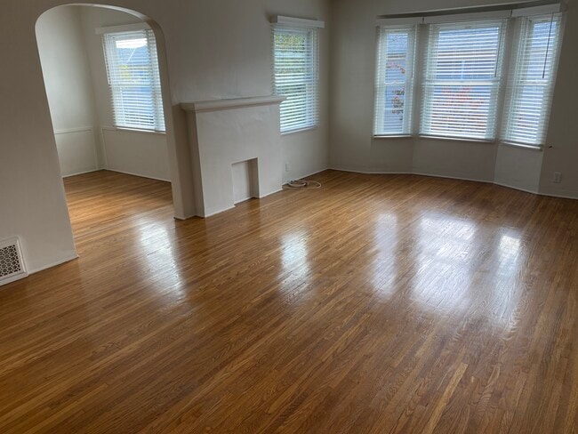 Living room and dining room with ceiling fan. - 449 San Vicente Blvd