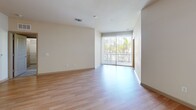 Located at 110 S Hoover Blvd in Tampa, FL, this well-appointed 2-bedroom, 2-bathroom residence offers a thoughtfully designed single-floor layout with a comfortable, functional living environment. The open-concept kitchen and living area serves as the heart of the home, featuring a central island with granite countertops, dark espresso cabinetry, stainless steel appliances including a range and over-the-range microwave, and a tile backsplash. Pendant lighting and a ceiling fan add both style and practicality to the space. Light hardwood-style flooring flows throughout the main living areas, complementing the neutral color palette and enhancing the bright, airy ambiance. Large sliding glass doors in the living room invite abundant natural light and provide outdoor views of lush greenery. Both bedrooms are carpeted and include ceiling fans; the primary bedroom is generously sized and connects to a walk-in closet equipped with wire shelving. The two bathrooms are finished with tile flooring and granite-topped dark vanities — one featuring a tub/shower combo with tiled surround, and the other a glass-enclosed walk-in shower. An in-unit washer and dryer area adds everyday convenience to this move-in ready Tampa residence.