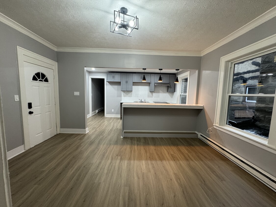 Main Living Area (Wide View)- Spacious living room with beautiful natural light and updated flooring - 898-902 Portland Ave