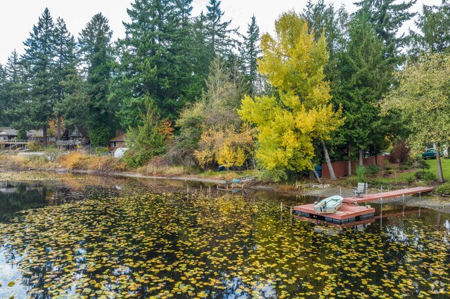 Bonney Lake is surrounded by tall mature trees with leaves that change colors.