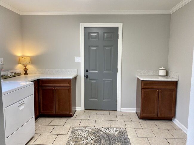 Laundry with cabinets for storage. - 127 W Young St.