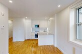 Located at 5530 Ch De La Côte-Saint-Luc in Montréal, this well-designed 2-bedroom, 1-bathroom unit offers a clean, modern aesthetic across a single floor. The layout flows from a welcoming hallway into an open living and kitchen area, where warm hardwood flooring, crisp white walls, and recessed lighting create a bright and inviting atmosphere. Windows in the main living area allow natural light to fill the space and offer views of the surrounding neighbourhood. The kitchen is efficiently integrated into the open-plan area, featuring a stovetop, sink, and ample counter space. Both bedrooms continue the consistent design language of the unit — light-toned hardwood floors, white walls, and individual windows that bring in natural light and ventilation. Each room also features a baseboard heater for year-round comfort. The primary bedroom offers a comfortable footprint, ideal for a full bedroom setup. The bathroom is a standout feature, finished with large-format grey tiles, a glass-enclosed walk-in shower with a rain showerhead and built-in niche, a modern white vanity, and recessed lighting — delivering a sleek, spa-like experience. Overall, the unit presents a cohesive, contemporary finish that is both functional and visually refined.