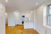 Located at 5530 Ch De La Côte-Saint-Luc in Montréal, this well-designed 2-bedroom, 1-bathroom unit offers a clean, modern aesthetic across a single floor. The layout flows from a welcoming hallway into an open living and kitchen area, where warm hardwood flooring, crisp white walls, and recessed lighting create a bright and inviting atmosphere. Windows in the main living area allow natural light to fill the space and offer views of the surrounding neighbourhood. The kitchen is efficiently integrated into the open-plan area, featuring a stovetop, sink, and ample counter space. Both bedrooms continue the consistent design language of the unit — light-toned hardwood floors, white walls, and individual windows that bring in natural light and ventilation. Each room also features a baseboard heater for year-round comfort. The primary bedroom offers a comfortable footprint, ideal for a full bedroom setup. The bathroom is a standout feature, finished with large-format grey tiles, a glass-enclosed walk-in shower with a rain showerhead and built-in niche, a modern white vanity, and recessed lighting — delivering a sleek, spa-like experience. Overall, the unit presents a cohesive, contemporary finish that is both functional and visually refined.