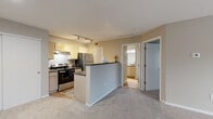 Located at 6108 Chestnut Ridge Dr in Columbus, Ohio, this one-bedroom, one-bathroom home offers a functional and well-organized single-floor layout. The open-concept kitchen and living area serves as the heart of the home, where the kitchen features light wood cabinetry, dark countertops, stainless steel appliances including a refrigerator and electric range, and track lighting overhead. A double sink with a window view adds practicality, while light hardwood-style flooring grounds the space with warmth. The kitchen flows naturally into the living room, which is carpeted and bathed in natural light through a large picture window overlooking the outdoors, creating an airy and inviting atmosphere. The bedroom is a comfortable retreat finished with plush carpet, neutral taupe walls, a textured ceiling, and a window that brings in additional natural light and outdoor views. The full bathroom is appointed with light wood vanity cabinetry, dark countertops, a full-size soaking tub with shower, and easy-care hardwood-style flooring. Throughout the home, a consistent neutral color palette of soft greige tones and clean white trim creates a cohesive, move-in-ready aesthetic that is both practical and welcoming.