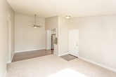 Located at 150 Drake St in Pomona, California, this single-floor residence offers a well-designed layout with a clean, contemporary aesthetic throughout. The open living area features vaulted ceilings with a stylish ceiling fan, dark hardwood-style flooring, and a seamless transition into carpeted spaces, creating a comfortable and versatile environment. A sliding glass door with vertical blinds allows natural light to pour into the carpeted room, adding a bright and airy quality to the space.

The kitchen is a standout feature, showcasing white shaker cabinetry, granite countertops, and a full suite of stainless steel appliances including a gas range, microwave, dishwasher, and refrigerator. A recessed ceiling light fixture adds a refined touch to the cooking area, which opens conveniently toward the main living space.

The bathrooms are finished with granite countertops, undermount sinks, brushed nickel fixtures, and wood-style flooring, reflecting a consistent design language carried throughout the home. The bedrooms offer plush carpeting and textured ceilings, providing a cozy retreat. Additional rooms feature the same dark hardwood-style flooring with vaulted ceilings and ceiling fans, enhancing both comfort and style. Overall, this residence presents a cohesive, updated interior with practical finishes.