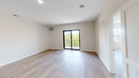 Located at 301 Memorial Dr in Neptune, NJ, this thoughtfully designed one-bedroom, one-bathroom residence offers a comfortable and modern living experience across a single floor. The open-concept layout connects the living area to a well-appointed kitchen, which features light wood cabinetry, dark granite countertops, a classic subway tile backsplash, and a full suite of stainless steel appliances including a gas range, microwave, and refrigerator. The kitchen peninsula provides additional counter space and a natural transition into the bright living area, which is finished with light hardwood flooring throughout. The spacious primary bedroom is bathed in natural light from a large window with pleasant outdoor views, and connects via a hallway to a dedicated closet. The bathroom is elegantly finished with a marble-style tiled tub and shower enclosure with sliding glass doors, a wood-toned vanity, and a dark granite countertop with an undermount sink. Recessed lighting throughout the residence adds a clean, modern ambiance. The living space also features sliding glass doors that open onto a private balcony, offering views of the surrounding greenery and bringing abundant natural light into the interior.