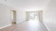 This 2-bedroom, 1-bathroom unit at 4427 Blossom St in Columbia, SC offers a well-organized single-floor layout designed for comfortable everyday living. The open living area is a standout feature, with light-toned luxury vinyl plank flooring running throughout and a large sliding glass door that fills the space with natural light while providing direct access to an outdoor area. Neutral-toned walls and clean white trim contribute to a bright, cohesive aesthetic throughout.

The kitchen is efficiently designed with white shaker-style cabinetry, dark granite-style countertops, a double stainless steel sink, and black appliances including a dishwasher and full-size refrigerator. A window above the sink adds natural light to the workspace.

Both bedrooms feature the same LVP flooring and neutral wall tones, creating a calm and versatile environment. The primary bedroom is generously proportioned and includes a closet with bi-fold doors. The secondary bedroom also offers a closet with double bi-fold doors and ample wall space.

The bathroom is clean and functional, featuring a full tub and shower combo with a white surround, a vanity with dark countertops, and wood-look tile flooring. A hallway connects the main living areas to the bedrooms and bathroom, completing this well-appointed layout.