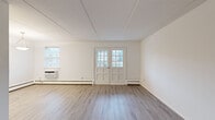 Located at 500 West Rosedale Avenue in West Chester, PA, this two-bedroom, one-bathroom residence offers a well-organized single-floor layout with a clean, updated aesthetic throughout. The living room is bright and open, featuring light-toned hardwood-style flooring, white walls, and a charming set of French doors with glass pane inserts that invite natural light and connect to additional living space. Baseboard heating and a wall-mounted AC unit provide year-round comfort.

The kitchen is thoughtfully appointed with white shaker-style cabinetry, light quartz countertops, a subway tile backsplash, and a full suite of stainless steel appliances including a refrigerator, electric range, microwave, and dishwasher. Light wood-style flooring continues throughout, adding to the cohesive feel.

The spacious primary bedroom features plush carpeting, two windows for natural light, a wall AC unit, and ample closet space with double bifold doors. The second bedroom also offers carpeting, a window with blinds, and baseboard heating. The full bathroom is finished with white subway tile surrounding the tub/shower combo, wood-style flooring, and a clean white vanity. Two hallways connect the spaces, contributing to an efficient and navigable floor plan.