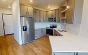This 530 square foot apartment in Fargo, North Dakota offers a thoughtful blend of functionality and style. The open-concept living area is illuminated by large windows, providing ample natural light and scenic views of the surrounding greenery. The modern kitchen is a standout feature, boasting sleek cabinetry, stainless steel appliances, and a distinctive geometric tile backsplash. The countertops extend to create a convenient breakfast bar, enhancing the space's versatility.

The apartment includes a dedicated laundry area with full-sized washer and dryer units, complemented by built-in storage shelves above. The bathroom continues the contemporary aesthetic with clean lines and a spacious layout. Throughout the apartment, warm wood flooring adds a touch of elegance and ties the spaces together cohesively.

Despite its compact size, the apartment's clever design ensures that every square foot is utilized effectively. Recessed lighting and neutral color palettes further contribute to the sense of spaciousness and modern appeal. This apartment presents an ideal living solution for those seeking a well-appointed, low-maintenance urban dwelling in Fargo.