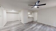 Located at 2207 Wickersham Lane in Austin, TX, this single-story residence offers two bedrooms and two bathrooms within a thoughtfully laid-out floor plan. Gray wood-look plank flooring extends throughout the home, providing a cohesive, modern aesthetic in every room.

The open living room is bright and welcoming, featuring a ceiling fan with light, vertical blinds, and a sliding glass door that allows natural light to filter in. The kitchen is well-equipped with white shaker-style cabinetry, granite countertops, a stainless steel refrigerator, a built-in microwave, an electric range, and a dishwasher. A breakfast bar adds functional counter space and connects the kitchen to the living area.

Both bedrooms are comfortably sized, with the primary bedroom offering generous proportions, a ceiling fan, and a dedicated closet. The second bedroom also features a ceiling fan and a large window that brings in ample natural light. Each room is finished with clean white walls and matching gray plank flooring.

The two bathrooms are designed with consistent finishes, each offering a tiled shower-tub combination, a granite-topped vanity, and wood-look flooring. A hallway connects the bedrooms and bathrooms, and two closets provide additional storage. The overall design is clean, neutral, and move-in ready.