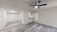 Located at 2207 Wickersham Lane in Austin, TX, this single-story residence offers two bedrooms and two bathrooms within a thoughtfully laid-out floor plan. Gray wood-look plank flooring extends throughout the home, providing a cohesive, modern aesthetic in every room.

The open living room is bright and welcoming, featuring a ceiling fan with light, vertical blinds, and a sliding glass door that allows natural light to filter in. The kitchen is well-equipped with white shaker-style cabinetry, granite countertops, a stainless steel refrigerator, a built-in microwave, an electric range, and a dishwasher. A breakfast bar adds functional counter space and connects the kitchen to the living area.

Both bedrooms are comfortably sized, with the primary bedroom offering generous proportions, a ceiling fan, and a dedicated closet. The second bedroom also features a ceiling fan and a large window that brings in ample natural light. Each room is finished with clean white walls and matching gray plank flooring.

The two bathrooms are designed with consistent finishes, each offering a tiled shower-tub combination, a granite-topped vanity, and wood-look flooring. A hallway connects the bedrooms and bathrooms, and two closets provide additional storage. The overall design is clean, neutral, and move-in ready.
