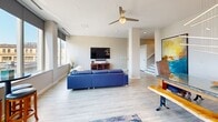 Located in the heart of downtown Canton, Ohio, this contemporary 2-bedroom, 4-bathroom residence offers a well-designed single-floor layout that balances style and functionality. The open living room is a standout space, featuring light hardwood-style flooring, recessed lighting, a ceiling fan, and expansive windows that frame striking panoramic views of the city skyline, flooding the room with natural light.

The galley-style kitchen is thoughtfully appointed with granite countertops, two-tone cabinetry — dark lower cabinets paired with crisp white uppers — a subway tile backsplash, and a full suite of stainless steel appliances, including a range, microwave, and refrigerator.

Both bedrooms are carpeted for comfort and include ceiling fans. The primary bedroom is generously proportioned and features a walk-in closet outfitted with custom dark wood built-ins, including shelving, hanging rods, a built-in countertop workspace, and cabinetry with frosted glass doors. Additional closets provide ample storage throughout the residence. Four bathrooms, finished in neutral tones with modern fixtures, ensure convenience for residents and guests alike. A dedicated laundry area houses a stacked full-size washer and dryer unit, adding everyday practicality to this polished urban residence.