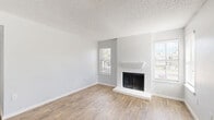 Located at 270 El Dorado Blvd in Houston, TX, this two-bedroom, two-bathroom single-floor residence offers a well-designed layout with a clean, neutral palette throughout. The open living area is anchored by a striking white-painted brick fireplace flanked by windows that invite natural light, all set atop warm wood-look flooring. The adjacent dining area flows seamlessly from the living space, with a pass-through connecting to the galley-style kitchen. The kitchen features white shaker cabinetry, light stone countertops, a subway tile backsplash, and black stainless steel appliances, including a range, microwave, refrigerator, and dishwasher. Both bedrooms are carpeted and fitted with ceiling fans, offering a comfortable retreat. The primary bedroom is generously sized and includes access to a spacious walk-in closet with wire shelving. The bathrooms are finished with white cabinetry, stone countertops, and framed mirrors. A dedicated in-unit laundry closet houses a full-size washer and dryer. Additional storage is provided by three closets in total. The space also includes a private balcony, adding an outdoor element to this well-appointed Houston home.