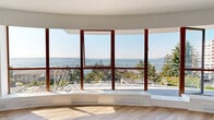 Located in the sought-after West Vancouver neighbourhood of Argyle Avenue, this two-bedroom residence offers a thoughtfully designed single-floor layout that balances comfort and style. The combined living and dining area is an immediate standout, anchored by a striking curved bay window with rich wood-toned frames that frame breathtaking panoramic views of the ocean and surrounding landscape. Light hardwood flooring runs throughout, enhancing the bright, airy ambiance that natural light generously provides across the space.

The kitchen is fully updated, featuring white shaker cabinetry, grey quartz countertops, a white subway tile backsplash, stainless steel appliances, and a peninsula ideal for casual dining or meal prep. A private balcony with decorative ironwork railing extends the living space outdoors, offering a serene spot to enjoy the coastal views.

The primary bedroom is generously proportioned and filled with natural light. Both bedrooms are serviced by well-appointed closets — six in total throughout the unit — providing excellent storage. The bathroom is finished in neutral tones with large-format floor tiles, a quartz vanity, full-width mirror, and subway tile surround. A hallway with mirrored sliding closet doors connects the rooms with ease, completing this refined West Vancouver residence.