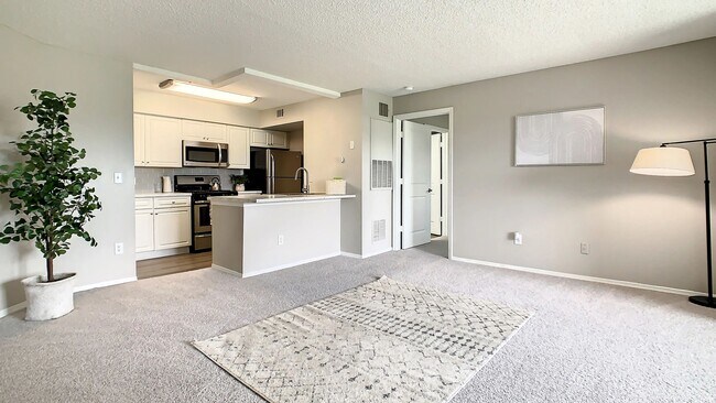 This spacious living area flows seamlessly into the kitchen, creating an inviting space for relaxing, entertaining, and enjoying everyday life at home. - Beachway Links