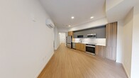 Located at 16853 Redmond Way, Unit 211, in Redmond, WA, this 700-square-foot apartment offers a thoughtfully designed single-floor layout with 2 bedrooms, 1 bathroom, and a dedicated laundry area. The open kitchen anchors the living space and features a sleek, modern design with two-tone cabinetry—warm wood lower cabinets paired with matte gray uppers—white quartz countertops, a white subway tile backsplash, and stainless steel appliances including a refrigerator, electric range, microwave, and dishwasher. Light wood-look flooring runs throughout the entire unit, lending a clean, cohesive aesthetic. The primary bedroom spans 130 square feet and includes access to a dedicated closet equipped with built-in shelving and a hanging rod. The second bedroom features a window with exterior views and a frosted-glass interior door, allowing natural light to flow while maintaining privacy. The bathroom is finished with floor-to-ceiling white tile surrounding a soaking tub and shower combo, complemented by matte black fixtures. A connecting hallway ties together all rooms efficiently. The unit also includes an in-unit laundry area, adding everyday convenience to this well-designed Redmond residence.