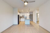 Located at 101 Zora Place in Lockhart, FL, this well-designed one-bedroom, one-bathroom unit offers a thoughtful layout across a single floor. The open-concept kitchen and living area serves as the heart of the space, featuring light wood-style flooring, recessed lighting, and a ceiling fan that enhances airflow and comfort. The kitchen is equipped with stainless steel appliances—including a refrigerator, range, microwave, and dishwasher—complemented by crisp white cabinetry, a tiled backsplash, and a central island with granite countertops and pendant lighting overhead. Large sliding glass doors in the living area invite natural light and provide exterior views. The bedroom is carpeted for comfort, includes a ceiling fan, and features a window with outdoor views. A den and two closets provide additional storage and flexible living options. The bathroom offers a white vanity with granite countertops, modern hardware, and a combined tub and shower. A dedicated laundry area and hallway round out the functional layout. The unit's clean, contemporary aesthetic is carried throughout with neutral tones, consistent finishes, and an efficient use of space.