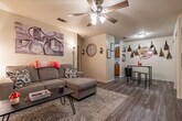 Located at 1010 N 1st St in Jacksonville, AR, this efficient one-bedroom, one-bathroom residence offers a well-organized layout across a single floor. The living room serves as the heart of the home, featuring hardwood-style flooring, a ceiling fan with light fixture, a textured ceiling, a fireplace, and a wall-mounted TV area. A large window dressed with sheer pink curtains allows natural light to fill the space, complementing the neutral walls and creating a warm, welcoming atmosphere.

The galley-style kitchen is lined with warm wood cabinetry on both sides, offering ample storage and counter space. It is equipped with an electric range and dishwasher, making efficient use of its compact footprint.

The bedroom accommodates a full-size bed comfortably and features a closet with wood-paneled doors, hardwood-style flooring, and a textured ceiling. The room's layout provides practical space for additional furnishings.

The bathroom is notably elongated, featuring a wood-toned vanity with a single sink and generous countertop space, a toilet, and a shower-tub combination. Hardwood-style flooring continues throughout, tying the space together with a cohesive aesthetic. Overall, this residence offers a practical and comfortable single-floor living experience.