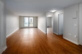 Located at 10 Overlea Dr in Kitchener, Ontario, this one-bedroom, one-bathroom unit offers a clean, functional layout with a bright and welcoming atmosphere throughout. Warm hardwood-style flooring runs continuously across every room, creating a cohesive and inviting feel from entry to bedroom.

The entryway opens into a generously sized living area, which is anchored by a large sliding glass door that floods the space with natural light and provides views of the surrounding neighbourhood. A baseboard heating system ensures year-round comfort.

The kitchen is efficiently designed with ample white cabinetry providing substantial storage, beige laminate countertops, a stainless steel double sink with a modern faucet, and a subway tile backsplash. The layout makes excellent use of the available space while maintaining a clean, contemporary aesthetic.

The bedroom is a well-proportioned retreat featuring a sliding window with outdoor views and a built-in double closet with integrated shelving and hanging rods, offering practical and organized storage. Baseboard heating is also present in this room.

The bathroom is finished with white subway tile surrounding a full soaker tub and shower combination, complemented by a vanity with a stone-look countertop and warm wood flooring that ties seamlessly to the rest of the unit.