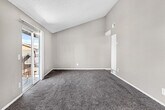 Located at 1112 W Devonshire Ave in Hemet, California, this single-story, 2-bedroom, 1-bathroom home offers a practical and comfortable layout across a well-utilized floor plan. The entrance opens into a combined living room and kitchen area, which serves as the heart of the home. The living room is a standout feature, boasting vaulted ceilings and a ceiling fan that enhance the sense of openness and airiness. Plush wall-to-wall carpeting runs throughout the living area, adding warmth underfoot. The kitchen is efficiently designed with light wood-style flooring, ample white cabinetry for storage, a gas range, a stainless steel sink, and light-toned countertops. A paneled ceiling light fixture provides bright, even illumination throughout the kitchen space. Both bedrooms are carpeted and comfortably sized, each offering a closet with shelving and hanging rods for convenient storage. Natural light filters into the bedrooms through windows that overlook the surrounding neighborhood. The bathroom features a full bathtub and shower combination, a vanity with a light countertop, and light wood-style flooring that ties the space together. Textured ceilings are present throughout the home, adding a classic residential character to the overall aesthetic.
