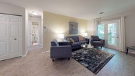 Located at 2330 Harpoon Ct in Henrico, Virginia, this single-floor residence offers a thoughtfully laid-out interior with a warm and comfortable ambiance throughout. The living room serves as the heart of the home, featuring light wood-style flooring, soft neutral-toned walls, and a pair of French doors that open onto a private deck overlooking lush, mature tree canopy — flooding the space with natural light and a sense of connection to the outdoors. The kitchen is well-appointed with white cabinetry, granite-look countertops, a mosaic tile backsplash, and stainless steel appliances including a refrigerator and dishwasher. A stacked washer and dryer unit is conveniently integrated into the kitchen area, adding practical in-unit laundry. The bedrooms are carpeted and generously proportioned, each offering bright windows with blinds that allow natural light to filter in, creating a calm and restful atmosphere. The bathroom is clean and functional, featuring a combined tub and shower with a curtain, a vanity with mirror, and neutral tile flooring. Overall, the home presents a cohesive, move-in-ready aesthetic with consistent neutral tones, practical finishes, and comfortable living spaces suited for everyday life.