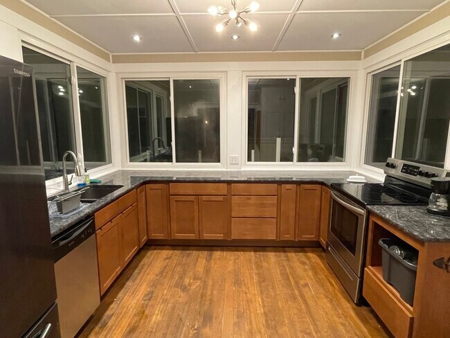Kitchen - Large fridge, flat-top electric stove - 1017 E Cache La Poudre St