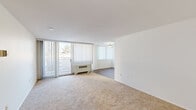 This two-bedroom, two-bathroom residence at 3701 Conshohocken Ave in Philadelphia offers a thoughtfully organized single-floor layout spanning a comfortable living footprint. The unit features two distinct living areas — one carpeted and one with wood-style flooring — providing flexible space for lounging or dining. Large sliding glass doors lead to a private balcony, allowing natural light to fill the main living space and offering outdoor views of the surrounding neighborhood.

The kitchen is well-equipped with ample white shaker cabinetry, dark countertops, a gas range, and a sink — all set atop durable wood-style flooring that continues throughout the cooking and dining areas.

The spacious primary bedroom features plush carpeting, a generous closet, and direct access to a private en-suite bathroom complete with a stand-up shower stall and white vanity. The second bedroom is similarly carpeted and well-proportioned, with its own closet. A second full bathroom features a tub/shower combination, white vanity with lighted mirror, and clean tile flooring.

A hallway connects the rooms efficiently, and additional closet storage contributes to the unit's practical design. The clean, neutral palette throughout creates a bright and welcoming ambiance.