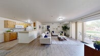 Located at 368 S Mall Dr in St. George, Utah, this single-floor, 3-bedroom, 1-bathroom unit offers a well-designed layout that maximizes its comfortable footprint. The open-concept main living area seamlessly connects the living room, dining area, and kitchen, creating a bright and cohesive space. Light wood-style flooring flows throughout the main area, complementing the neutral white walls and contributing to an airy, clean aesthetic.

The kitchen features warm-toned natural wood cabinetry, white appliances including a gas range and refrigerator, and a peninsula breakfast bar that opens to the living and dining spaces — ideal for everyday functionality. The dining area accommodates a full table and is accented by stylish wall décor.

The living room is generously sized, offering ample room for multiple seating arrangements, and includes a sliding glass door that leads to a private patio with outdoor views, allowing natural light to fill the space.

The primary bedroom is notably spacious, featuring plush carpeting for added comfort. Two additional bedrooms provide flexible options for roommates, guests, or a home office. The full bathroom includes a single-sink vanity with wood cabinetry and a shower/tub combination. A dedicated laundry room with washer and dryer hookups rounds out the practical features of this well-appointed unit.