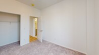 Located at 710-712 Main St in Middletown, CT, this two-bedroom, one-bathroom unit offers a well-designed single-floor layout with a clean, modern aesthetic throughout. The kitchen is a standout feature, showcasing granite countertops, white shaker-style cabinetry, a classic subway tile backsplash, stainless steel appliances including a refrigerator and dishwasher, and the added convenience of an in-unit washer. Light hardwood-style flooring runs through the kitchen and connecting hallways, adding warmth and continuity to the space. Both bedrooms are carpeted and bathed in natural light courtesy of double-hung windows that frame views of the surrounding streetscape. The rooms feature crisp white walls and clean lines, creating a bright and neutral canvas. The primary bedroom offers a comfortable footprint with direct access to the hallway. The full bathroom is finished with large-format marble-style tile covering both the floor and the tub surround, complemented by a white vanity with brushed gold hardware, lending a polished, contemporary feel. Multiple hallways provide functional flow between the rooms. Overall, the unit presents a fresh, move-in-ready environment with thoughtful finishes that balance practicality and style in a convenient Middletown location.