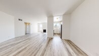 Located at 4150 Arch Dr in the Studio City neighborhood of Los Angeles, this one-bedroom, one-bathroom residence offers a bright and clean modern aesthetic throughout its well-organized single-floor layout. Light wood-style flooring runs continuously throughout the space, complementing the crisp white walls and creating a cohesive, airy feel.

The open living room is a standout feature, boasting a fireplace flanked by large windows fitted with vertical blinds that allow abundant natural light to fill the room. Sliding glass doors lead to a balcony with open views of the surrounding Los Angeles neighborhood, while additional tall accent windows further enhance the sense of openness.

The kitchen is efficiently designed with white cabinetry, a stainless steel refrigerator, a gas range, and a window above the sink that brings in natural light. It connects conveniently to the main living area via a hallway.

The generously sized primary bedroom offers ample space and provides access to a closet and the bathroom. The bathroom features a wide dual-sink vanity with white cabinetry, a large mirror, and stylish vanity lighting, delivering a clean and functional design.

A dedicated hallway and closet round out the layout, contributing to the overall practicality of this well-appointed Los Angeles residence.