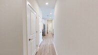 Located at 1330 Nashville Pike in Gallatin, TN, this two-bedroom, two-bathroom residence offers a thoughtfully designed single-floor layout with modern finishes throughout. Light wood-style flooring flows seamlessly across all rooms, creating a bright and cohesive aesthetic.

The open-concept kitchen and living area serves as the heart of the home. The kitchen features white shaker cabinetry, granite countertops, stainless steel appliances including a refrigerator, electric range, and microwave, and a central island with a undermount sink — ideal for both meal prep and casual dining.

Both bedrooms are well-proportioned and filled with natural light from large windows fitted with horizontal blinds. Ceiling fans are present in each bedroom, contributing to year-round comfort. The spacious primary bedroom includes direct access to a dedicated closet area. Each bedroom offers a calm, neutral palette with clean lines.

The two bathrooms are finished with granite-topped white vanities, wood-style flooring, and white subway tile surrounding the tub-shower combinations. Built-in open shelving in one bathroom adds practical storage. A second closet provides additional organizational space within the unit.

Overall, the residence presents a clean, contemporary feel with consistent, quality finishes suitable for comfortable everyday living in Gallatin, Tennessee.