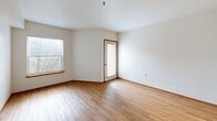 Located at 945 NW Naito Pkwy in Portland's vibrant Pearl District/Old Town waterfront neighborhood, this efficiently designed unit makes excellent use of its compact footprint. The main living area features warm-toned hardwood-style flooring and clean white walls, creating a bright, open feel. Large windows allow natural light to filter in, adding to the airy ambiance, while a door leads directly to a private balcony—ideal for enjoying outdoor views.

The galley-style kitchen is positioned off the main living space and includes white cabinetry with wood-tone trim, a built-in electric range and oven, a refrigerator, and an overhead exhaust fan. The layout is practical and well-organized for everyday use.

The bathroom is finished with light-toned flooring and features a full soaking tub with a shower surround, complemented by clean white walls and chrome fixtures. Two closets provide ample storage throughout the unit, helping to maximize the use of space.

Throughout the unit, consistent wood-trimmed doors and white walls maintain a cohesive, clean aesthetic. The overall design is simple and functional, offering a comfortable living environment in a prime Portland location with convenient access to the waterfront and urban amenities.
