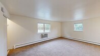 Located at 150 E Atlantic Ave in Somerdale, NJ, this one-bedroom, one-bathroom unit offers a practical and comfortable single-floor layout. The living room is generously sized, featuring neutral carpet flooring, cream-toned walls, and multiple windows that allow ample natural light and views of the surrounding greenery. Baseboard heating and a wall-mounted air conditioning unit ensure year-round comfort. The adjoining dining area flows naturally from the living space, with hardwood flooring that extends into the kitchen. The kitchen is efficiently designed with warm oak cabinetry, dark speckled countertops, a gas range, an over-the-range microwave, and a window above the sink that brings in additional natural light. The bedroom offers a comfortable footprint with plush carpet flooring, a closet, and a window with outdoor views. Two additional closets throughout the unit provide generous storage. The bathroom is finished in crisp white, featuring a tub/shower combination with tiled surround, a window for natural ventilation, and tile flooring. With three closets total, the unit offers practical storage solutions throughout. The clean, neutral palette and functional layout make this a versatile and move-in-ready space.