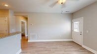 Located at 4938 Worth Way in Bowling Green, Kentucky, this 1-bedroom, 1-bathroom unit offers a thoughtfully designed single-floor layout with modern finishes throughout. The open-concept kitchen and living room serves as the heart of the home, featuring light-toned luxury vinyl plank flooring that flows seamlessly throughout the space. The kitchen is equipped with crisp white shaker-style cabinetry, granite-look countertops, and a full suite of stainless steel appliances, including a range, over-the-range microwave, and refrigerator.

The living area is bright and airy, benefiting from multiple windows dressed with white blinds that invite natural light. A ceiling fan provides both comfort and ambiance. The entry door includes a glass panel, further enhancing the sense of openness.

The bedroom is a comfortable, well-proportioned retreat with its own ceiling fan, a large window offering natural light, and the same consistent flooring found throughout the unit. The bathroom features a full tub-shower combination, a white vanity with granite-look countertop, and clean, neutral finishes. Additional spaces include a hallway and a utility room, adding practical functionality. The unit's neutral gray palette and modern touches create a clean, move-in-ready atmosphere.