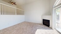 Located at 2500 Chalmette Ct in Rocklin, CA, this three-bedroom, two-bathroom tri-level home offers a well-organized layout spread across three floors. The ground level features a generously sized garage with ample concrete flooring, overhead lighting, and an automatic opener, with interior stair access leading to the main living areas above.

The main floor showcases an open-concept kitchen and living room combination. The kitchen is equipped with warm honey-toned cabinetry, dark granite countertops, stainless steel appliances including a gas range, microwave, dishwasher, and refrigerator, plus a central island for added workspace. Rich hardwood flooring ties the kitchen together seamlessly. The adjacent living room impresses with soaring vaulted ceilings, a ceiling fan, soft carpeting, a fireplace, and a striking arched window above sliding glass doors that open to an outdoor area with pool views, flooding the space with natural light.

The upper floor hosts all three bedrooms and two bathrooms. The generously sized primary bedroom features vaulted ceilings, a ceiling fan, plush carpet, and a walk-in closet with built-in hanging rods. The secondary bedrooms are bright and well-proportioned with natural light. The bathrooms are finished with granite countertops, wood-toned cabinetry, and tile flooring.