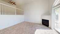Located at 2500 Chalmette Ct in Rocklin, CA, this three-bedroom, two-bathroom tri-level home offers a well-organized layout spread across three floors. The ground level features a generously sized garage with ample concrete flooring, overhead lighting, and an automatic opener, with interior stair access leading to the main living areas above.

The main floor showcases an open-concept kitchen and living room combination. The kitchen is equipped with warm honey-toned cabinetry, dark granite countertops, stainless steel appliances including a gas range, microwave, dishwasher, and refrigerator, plus a central island for added workspace. Rich hardwood flooring ties the kitchen together seamlessly. The adjacent living room impresses with soaring vaulted ceilings, a ceiling fan, soft carpeting, a fireplace, and a striking arched window above sliding glass doors that open to an outdoor area with pool views, flooding the space with natural light.

The upper floor hosts all three bedrooms and two bathrooms. The generously sized primary bedroom features vaulted ceilings, a ceiling fan, plush carpet, and a walk-in closet with built-in hanging rods. The secondary bedrooms are bright and well-proportioned with natural light. The bathrooms are finished with granite countertops, wood-toned cabinetry, and tile flooring.