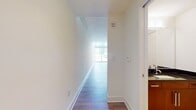 This two-story property offers a total of 1,170 square feet of living space, with 540 square feet on the ground floor and 630 square feet on the upper level. The home features 7 rooms, providing ample space for various living arrangements. 

The interior showcases a striking blend of modern and industrial design elements. One of the most notable features is the polished concrete flooring, which adds a sleek, contemporary touch while also providing durability and easy maintenance. The rich, warm tones of the concrete create an inviting atmosphere and contrast beautifully with the crisp white walls.

A modern ceiling fan with an integrated light fixture enhances both the aesthetics and functionality of the space, ensuring proper air circulation and illumination. The room's clean lines and minimalist design are further accentuated by the absence of baseboards, creating a seamless transition between the floors and walls.

An eye-catching sliding barn door serves as a stylish room divider, adding a touch of rustic charm to the otherwise modern space. This feature not only provides privacy when needed but also allows for an open-concept feel when desired. The door's white finish complements the wall color, maintaining a cohesive look throughout the property.

The property's layout and design elements make it well-suited for those who appreciate a contemporary aesthetic with industrial influences. The combination of ample square footage and thoughtful design creates a living space that is both functional and visually appealing.