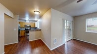 Located at 3930 NW Witham Hill Dr in Corvallis, Oregon, this single-floor residence offers a well-organized and functional layout throughout. The living area is spacious and inviting, featuring rich hardwood-style flooring, a ceiling fan with integrated lighting, and a large window that brings in natural light while offering outdoor views. A sliding glass door provides direct access to a private deck, seamlessly connecting indoor and outdoor living.

The kitchen is well-appointed with warm wood cabinetry, granite-style countertops, a stainless steel range, and ample storage and counter space. A breakfast bar serves as a practical pass-through between the kitchen and the adjacent dining and living areas. The kitchen also features a window above the sink for additional natural light.

The bedrooms are carpeted for comfort, with one featuring a large walk-in closet with built-in shelving. Windows in the bedrooms allow natural light to filter through, and a baseboard heater provides warmth. The bathroom is cleanly finished with stone-look tile flooring, a tub-shower combination, and a vanity with granite-style countertops. Throughout the residence, neutral tones and clean lines create a cohesive and comfortable living environment.